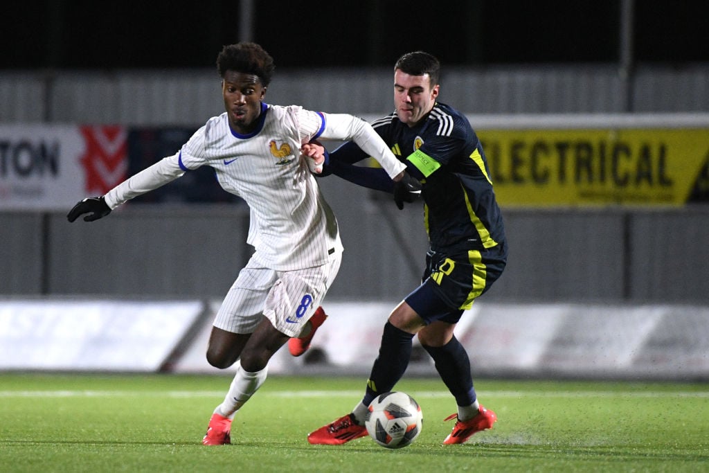 Aladji Bamba of France U19s runs with the ball whilst under pressure from Lennon Miller of Scotland U19s