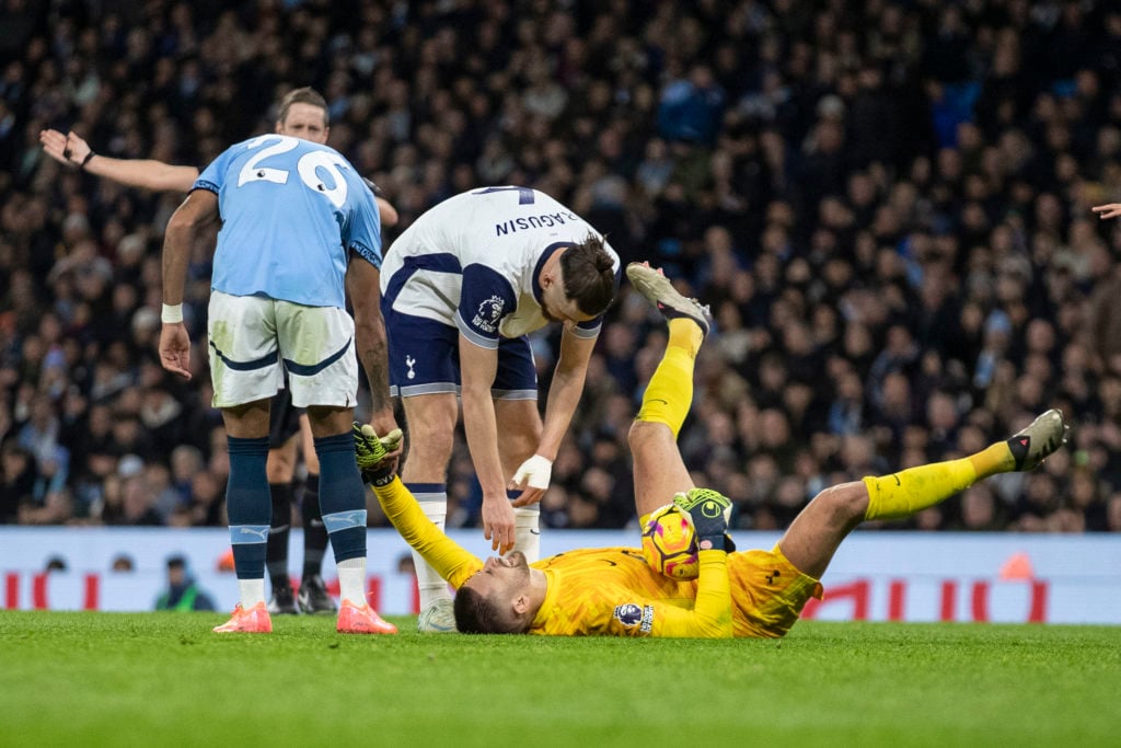 Guglielmo Vicario #1 (GK) of Tottenham Hotspur F.C. is fouled by Savinho #26 of Manchester City F.C. during the Premier League match between Manche...