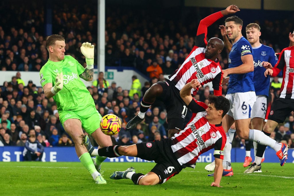 Jordan Pickford of Everton is fouled by Christian Norgaard of Brentford who is subsequently sent-off  during the Premier League match between Evert...