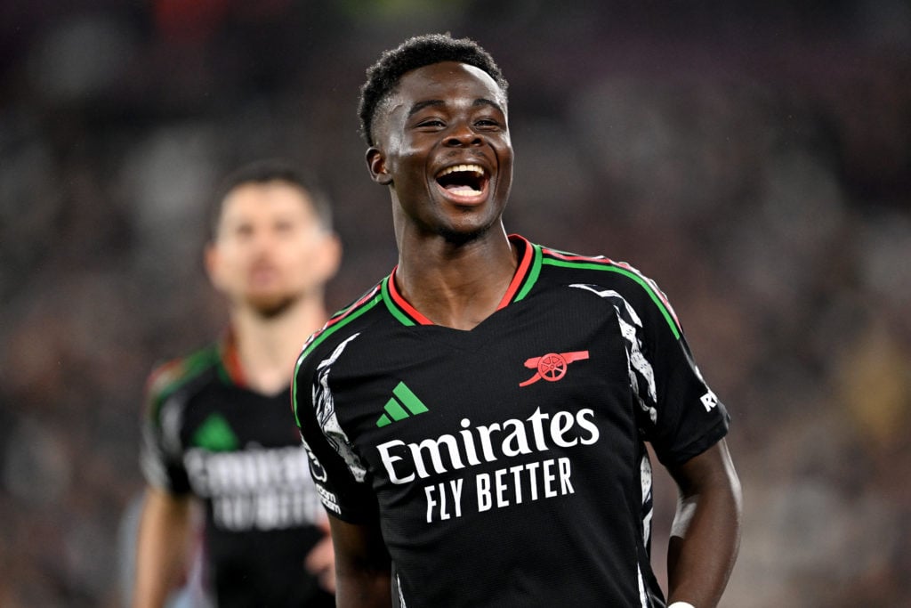 Bukayo Saka of Arsenal celebrates scoring his team's fifth goal from a penalty kick during the Premier League match between West Ham United FC and ...