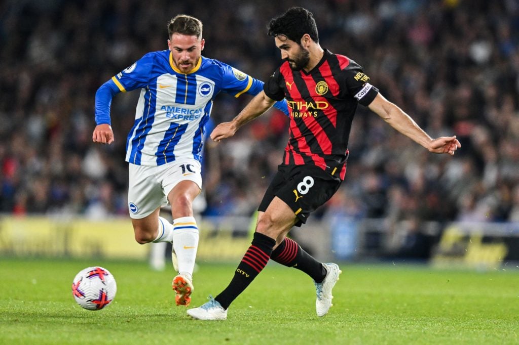 Brighton's Argentinian midfielder Alexis Mac Allister (L) fights for the ball with Manchester City's German midfielder Ilkay Gundogan during the En...