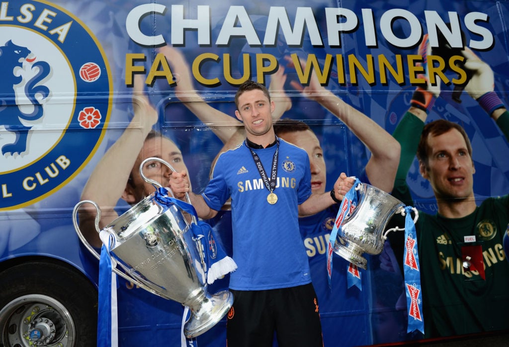 (EXCLUSIVE COVERAGE)  Gary Cahill poses with the Champions League trophy and FA Cup during the Chelsea victory parade following their UEFA Champion...