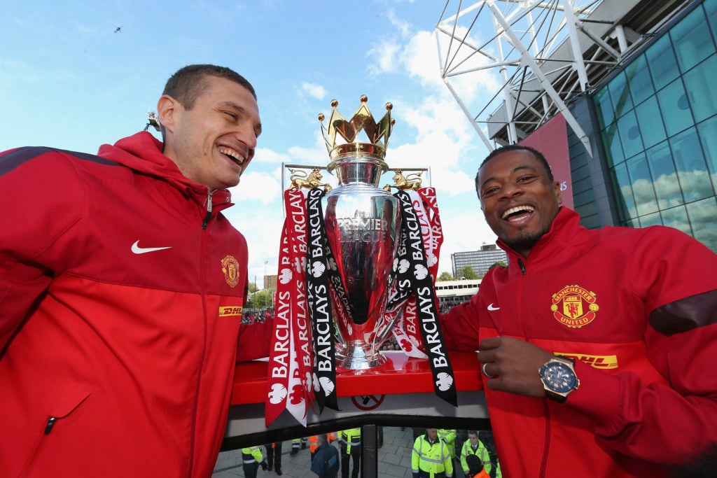 Nemanja Vidic and Patrice Evra of Manchester United poses with the Premier League trophy on their Barclays Premier League Trophy Parade through Man...