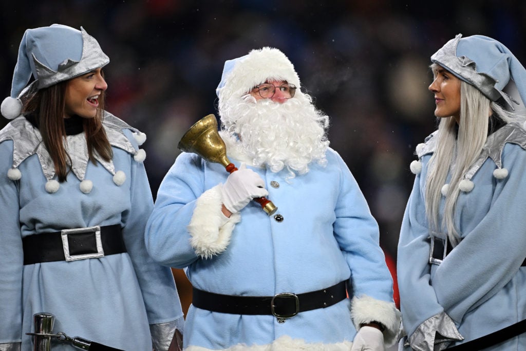 A member of the public dressed as Santa Claus shows their support prior to the Premier League match between Manchester City and Tottenham Hotspur a...