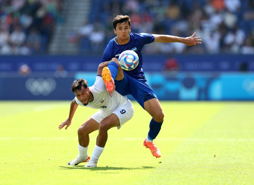 Abdukodir Khusanov #3 of Team Uzbekistan and Rafael Nunez #9 of Team Dominican Republic during the Men's group C match between Dominican Republic a...