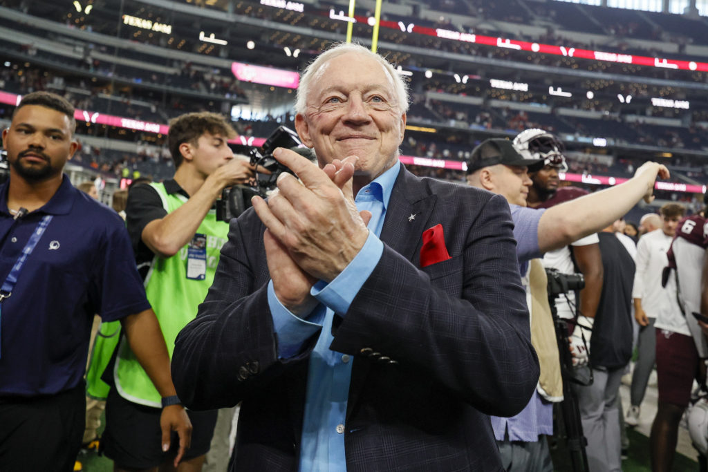 Dallas Cowboys owner and GM Jerry Jones applauds the Texas A&M Aggies band after the Southwest Classic game between the Arkansas Razorbacks and...