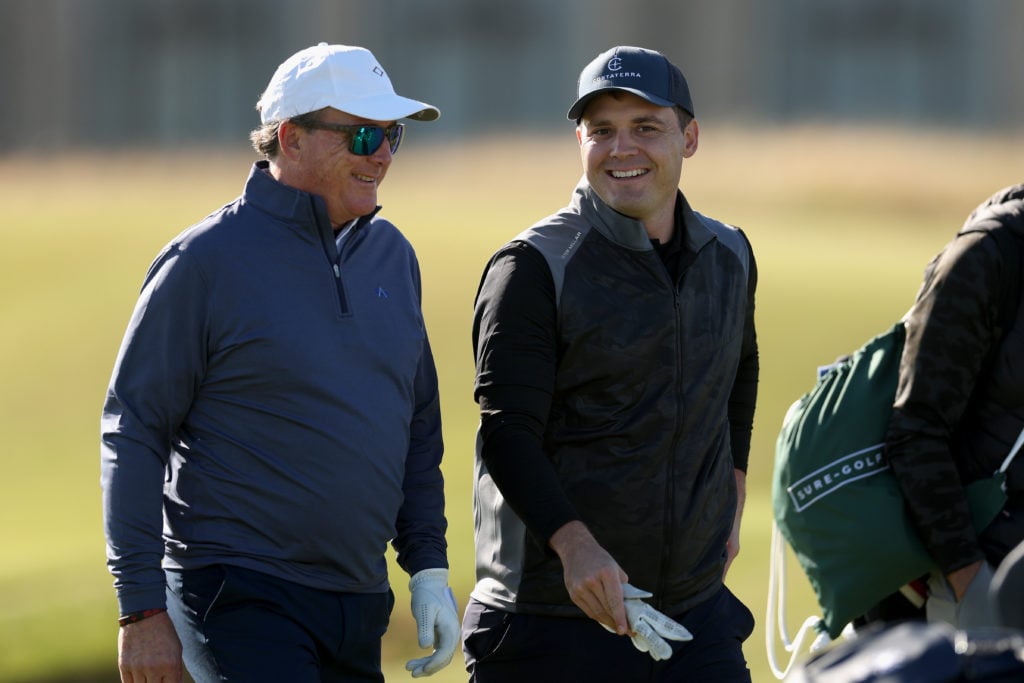 CEO of The Friedkin Group, Dan Freidkin interacts with his son, Ryan Freidkin, Co-Founder of Imperative Entertainment during a practice round prior...