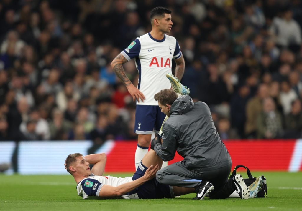 Micky van de Ven of Tottenham Hotspur receives medical treatment for an injury and is substituted off the pitch injured during the Carabao Cup Four...