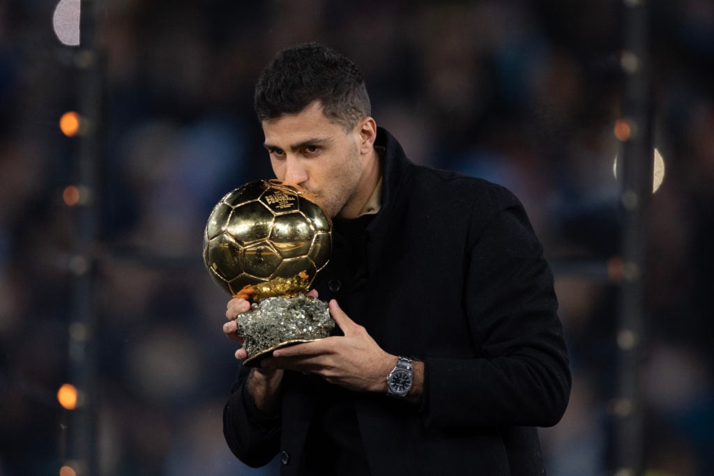 Rodri of Manchester City poses for a photo with his Ballon d'Or award prior to the Premier League match between Manchester City FC and Tottenham Ho...