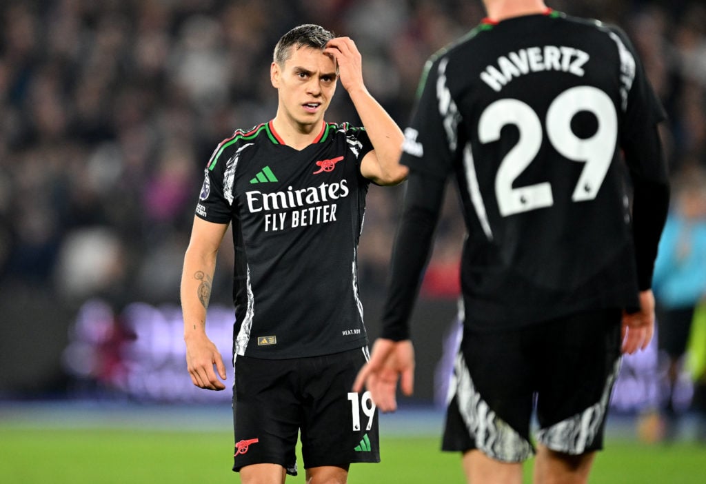 Leandro Trossard of Arsenal speaks with teammate Kai Havertz during the Premier League match between West Ham United FC and Arsenal FC at London St...