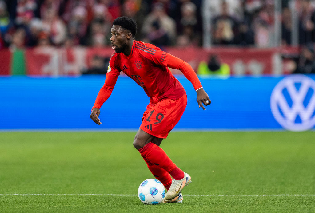 Alphonso Davies of FC Bayern Muenchen runs with the ball during the DFB Cup round of 16 match between FC Bayern München and Bayer 04 Leverkusen at ...