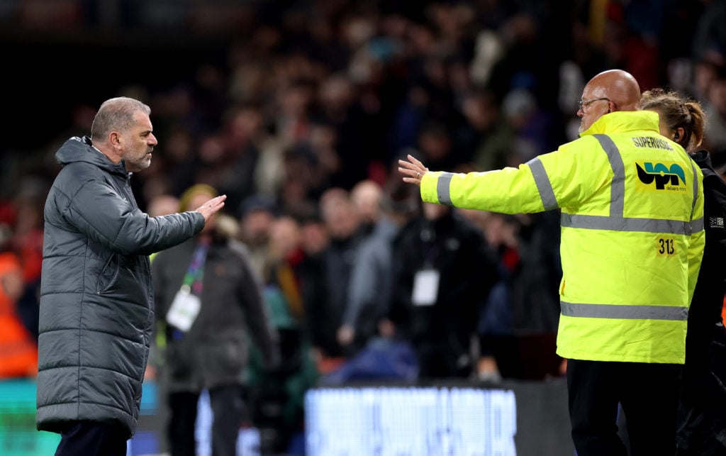 A match supervisor intervenes as Ange Postecoglou, Manager of Tottenham Hotspur, exchanges words with the Tottenham Hotspur fans at the end of the ...