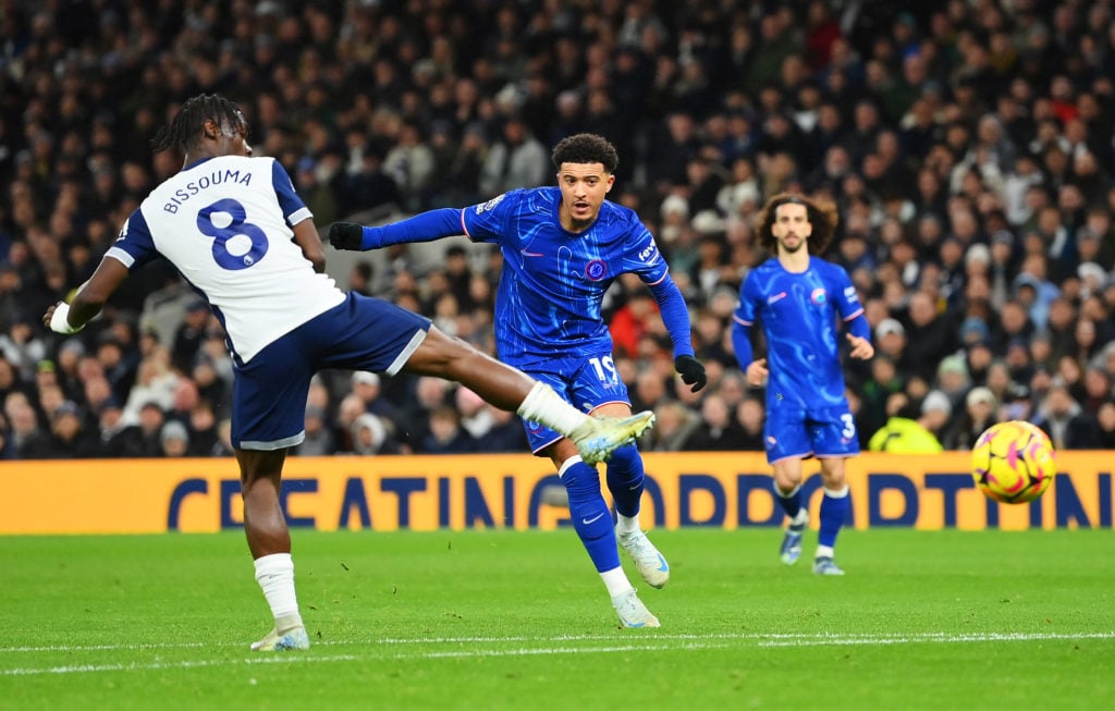 Jadon Sancho of Chelsea scores his team's first goal under pressure from Yves Bissouma of Tottenham Hotspur during the Premier League match between...