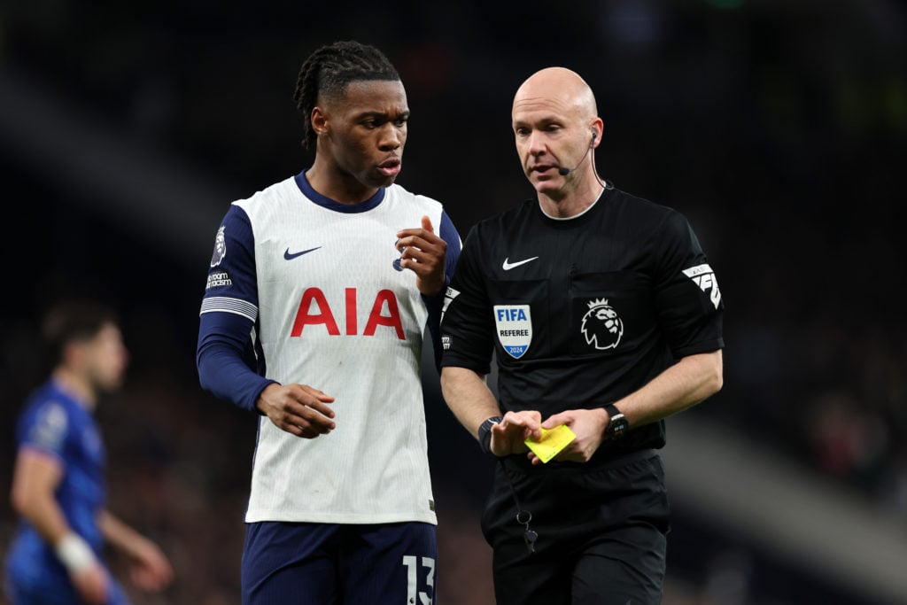 Destiny Udogie of Tottenham Hotspur speaks with Referee Anthony Taylor during the Premier League match between Tottenham Hotspur FC and Chelsea FC ...