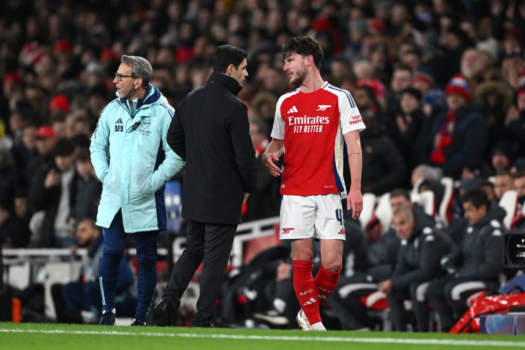 Mikel Arteta, Manager of Arsenal, speaks with Declan Rice of Arsenal as he leaves the pitch after being substituted during the UEFA Champions Leagu...