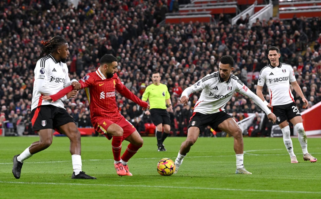 (SUN AND SUN ON SUNDAY OUT) Mohamed Salah of Liverpool is challenged by Alex Iwobi and Antonee Robinson of Fulham during the Premier League match b...