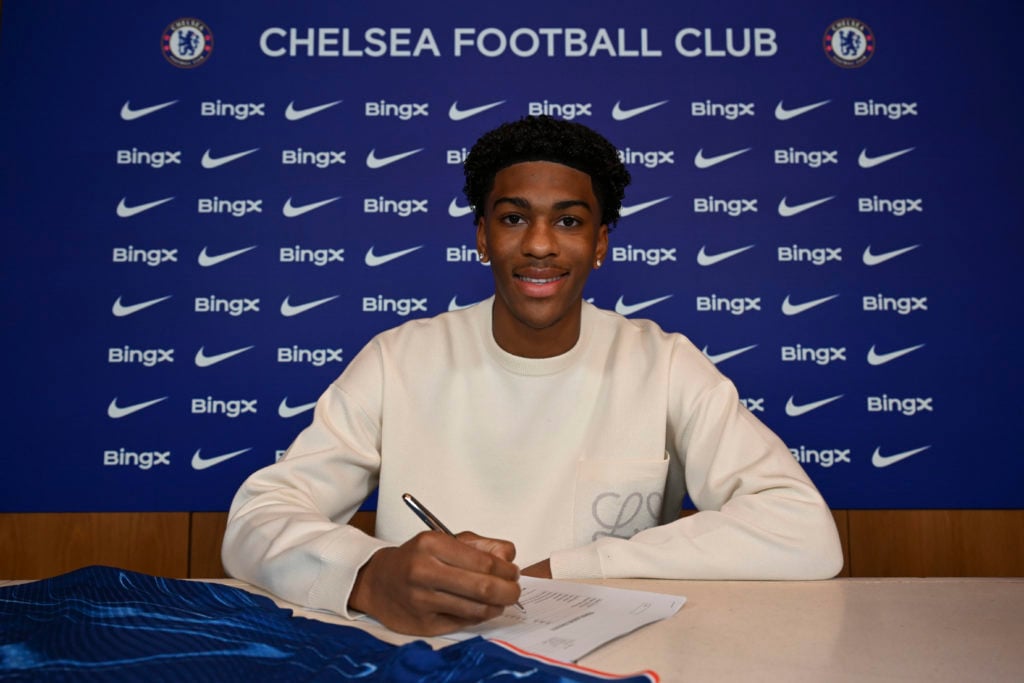 Josh Acheampong of Chelsea signs a new contract at Chelsea Training Ground on December 18, 2024 in Cobham, England.