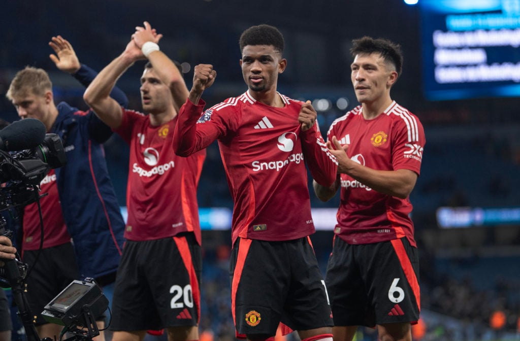 Scorer of the winning goal Amad Diallo of Manchester United celebrates with team mates Diogo Dalot and Lisandro Martinez after the Premier League m...