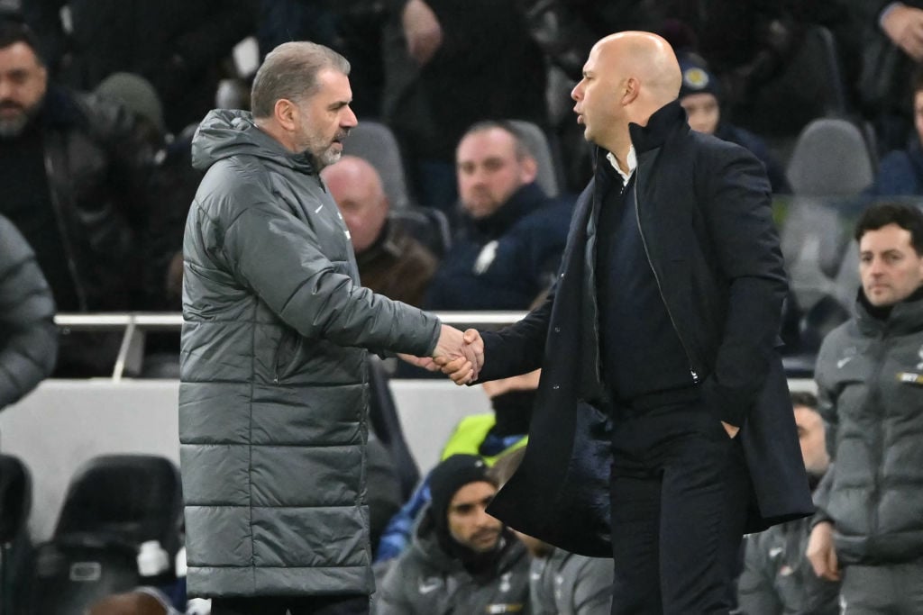 Liverpool's Dutch manager Arne Slot (R) shakes hands with Tottenham Hotspur's Greek-Australian Head Coach Ange Postecoglou (L) after the English Pr...