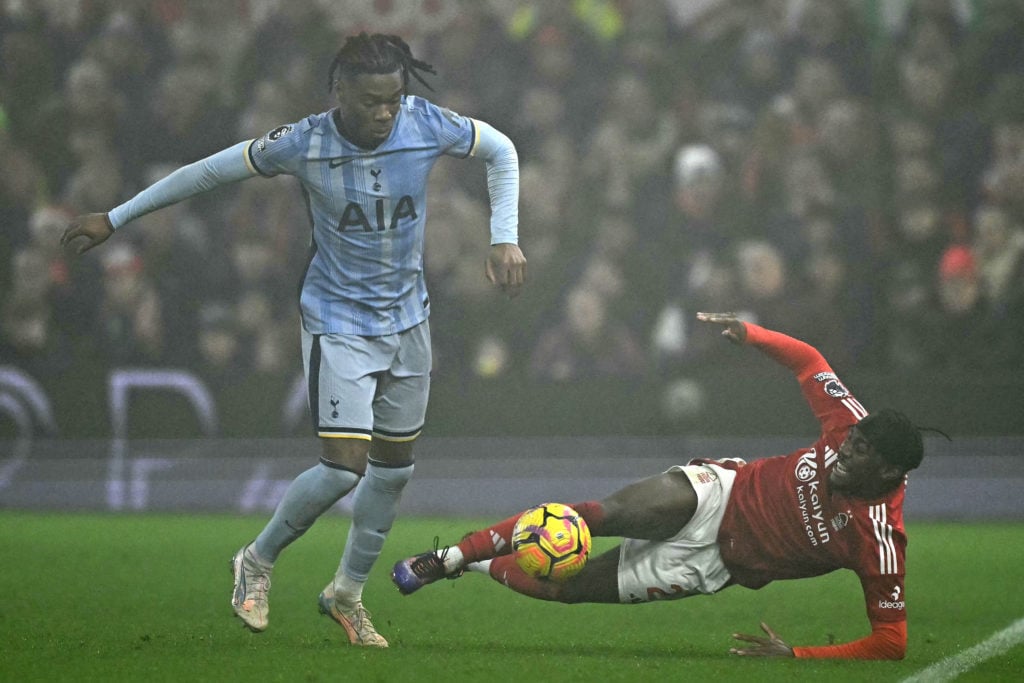 Tottenham Hotspur's Italian defender #13 Destiny Udogie (L) vies with Nottingham Forest's Swedish midfielder #21 Anthony Elanga (R) during the Engl...