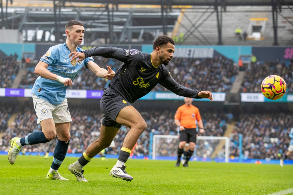 Iliman Ndiaye #10 of Everton F.C. is challenged by Phil Foden #47 of Manchester City F.C. during the Premier League match between Manchester City a...