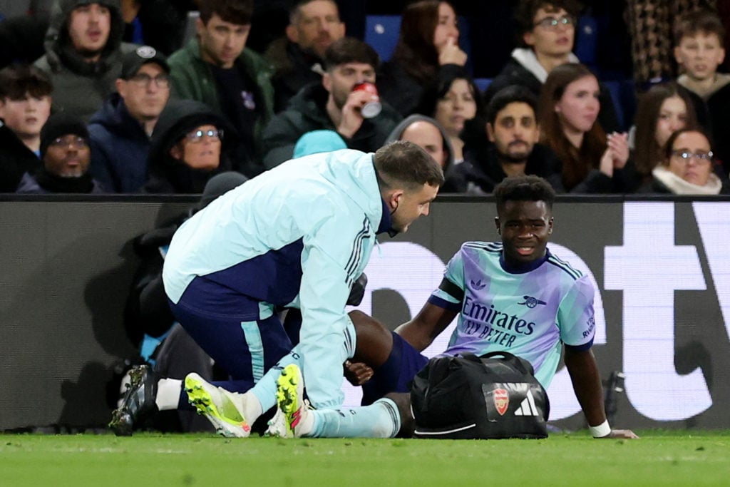 Bukayo Saka of Arsenal receives medical treatment after picking up an injury during the Premier League match between Crystal Palace FC and Arsenal ...