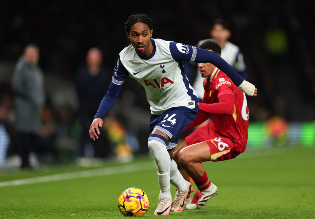 Djed Spence of Tottenham Hotspur runs with the ball under pressure from Trent Alexander-Arnold of Liverpool during the Premier League match between...