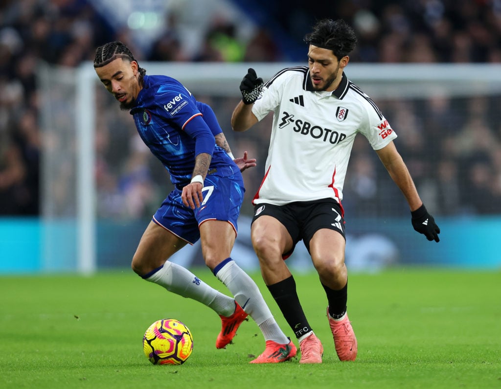 Malo Gusto of Chelsea is challenged by Raul Jimenez of Fulham during the Premier League match between Chelsea FC and Fulham FC at Stamford Bridge o...