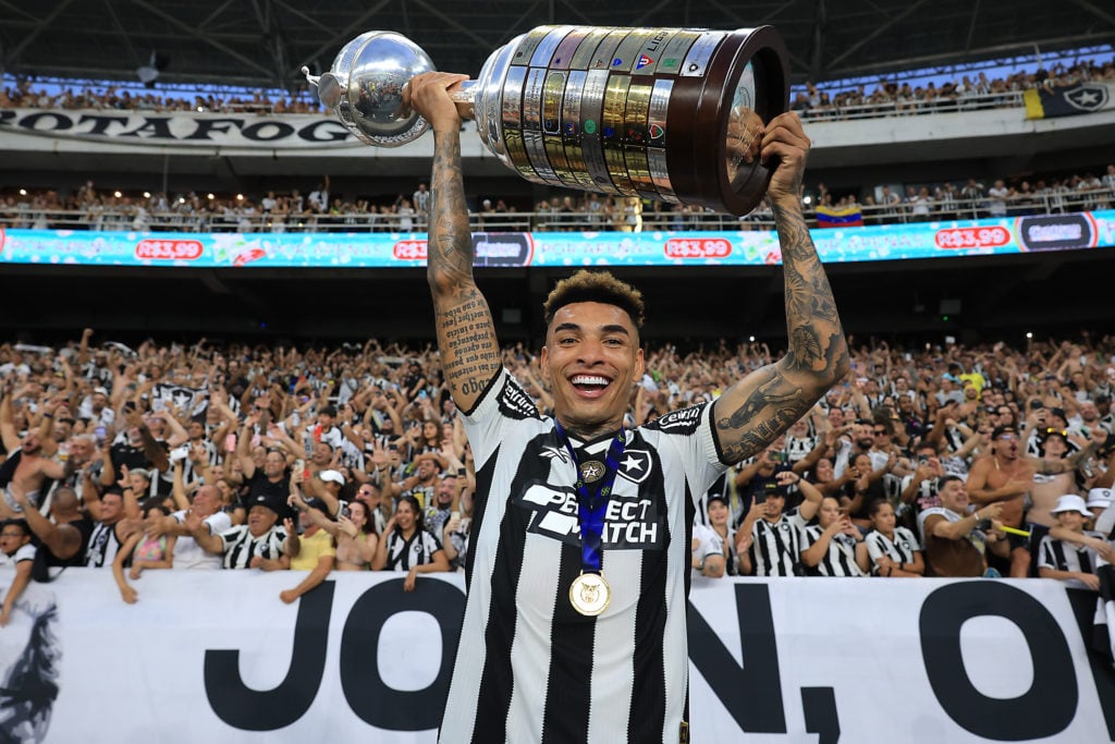 Igor Jesus of Botafogo poses with the Libertadores champions trophy after a match between Botafogo and Sao Paulo as part of Brasileirao 2024 at Es...