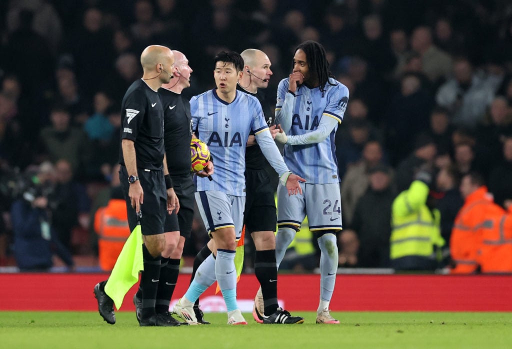 Son Heung-Min and Djed Spence of Tottenham Hotspur appeals to the officials as they walk off at half time of the Premier League match between Arsen...