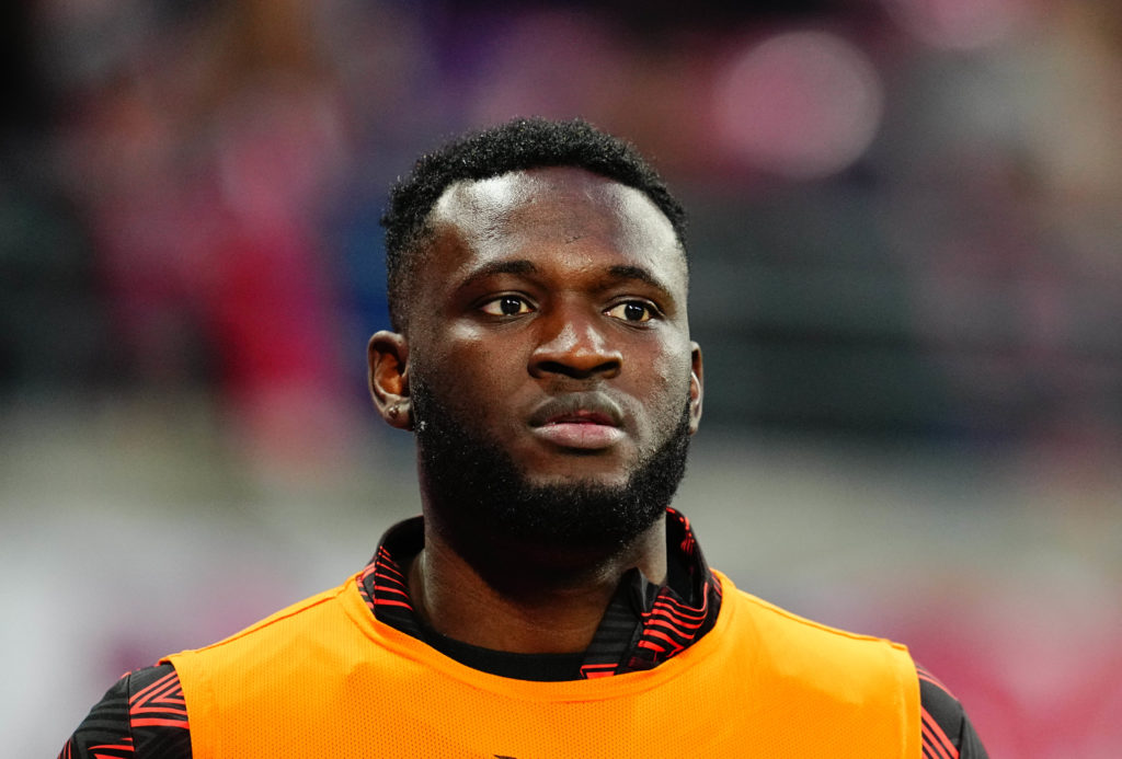 Victor Boniface looking on while warming up during a Bayer Leverkusen game