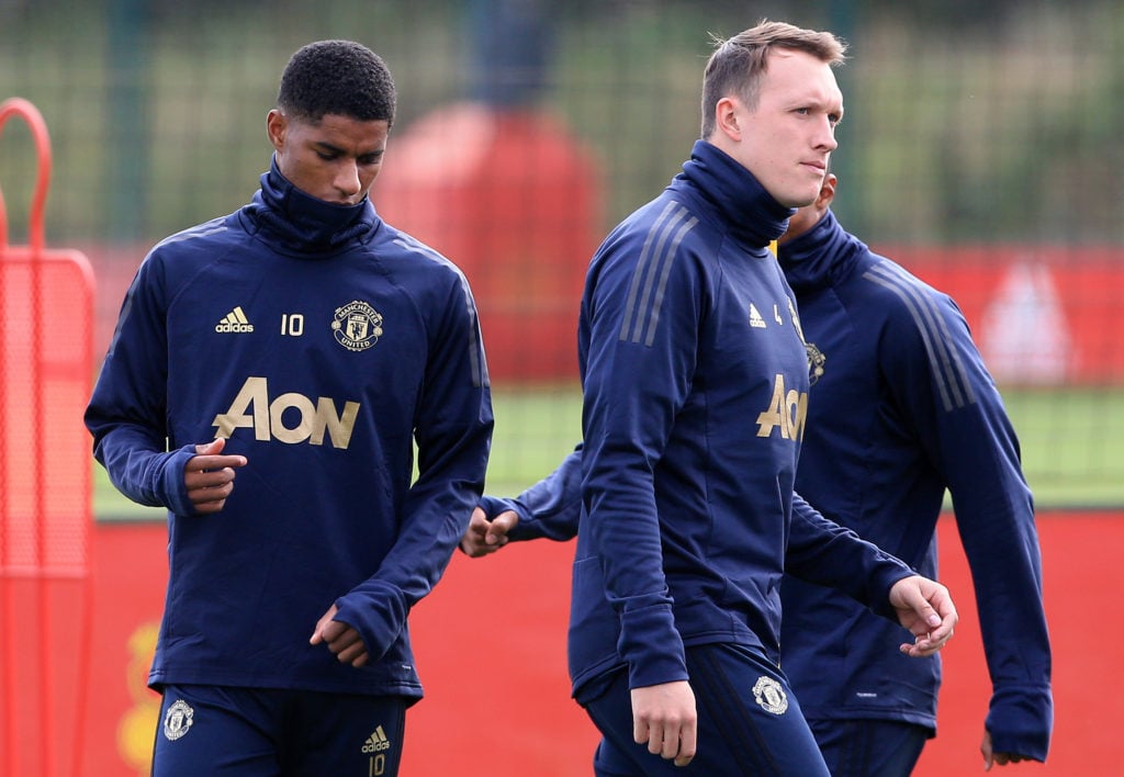 Manchester United's English striker Marcus Rashford (L) and Manchester United's English defender Phil Jones attend a training session at the Carrin...