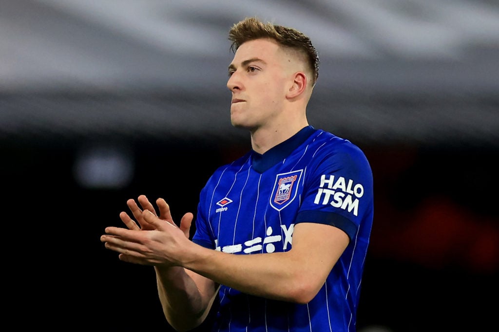 Liam Delap applauds fans after a Premier League match for Ipswich Town.