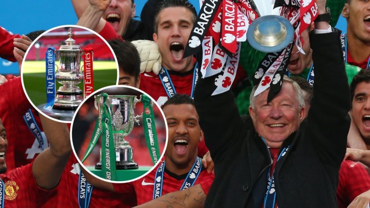 Manchester United Manager Sir Alex Ferguson lifts the Premier League trophy following the Barclays Premier League match between Manchester United a...