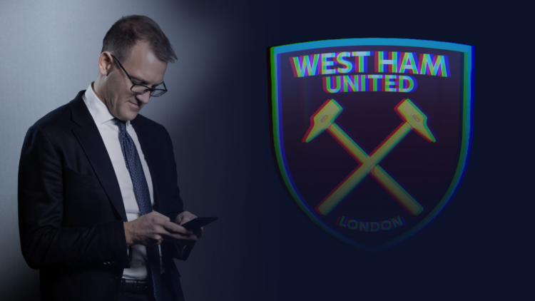 Daniel Kretinsky uses his mobile phone, with an image of the West Ham badge superimposed