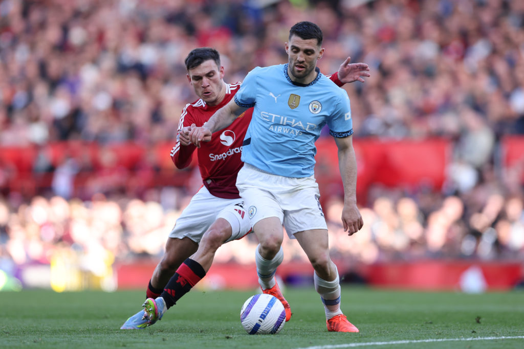 Mateo Kovacic of Manchester City battles for possession with Manuel Ugarte of Manchester United during the Premier League clash at Old Trafford.