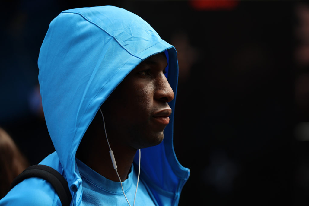 Nicolas Jackson with a hoodie on looking on before a Chelsea game