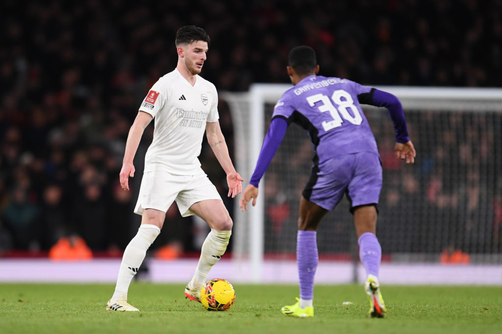 Declan Rice of Arsenal runs with the ball under pressure from Ryan Gravenberch of Liverpool