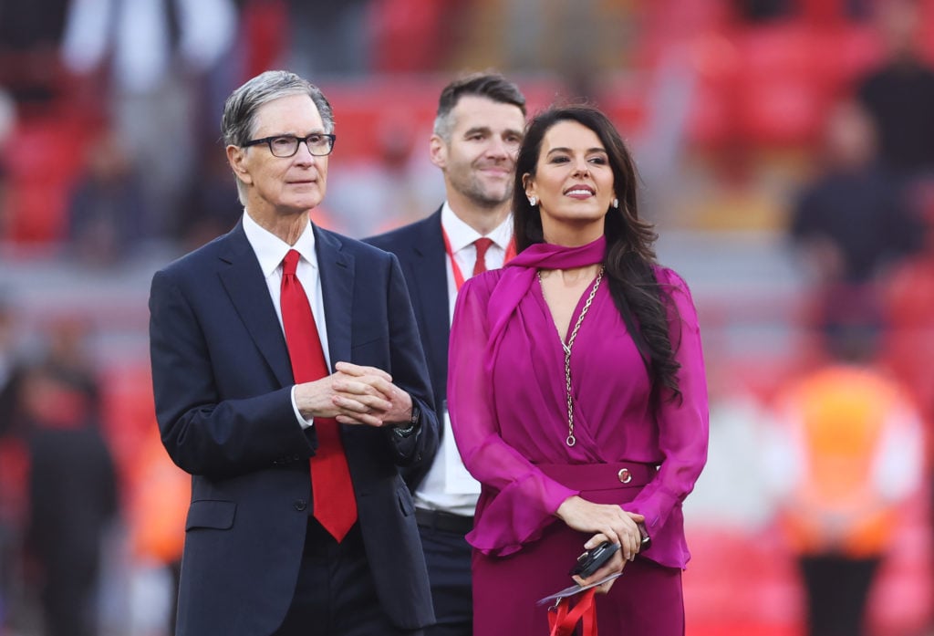 Liverpool owners John Henry and his wife Linda Pizzuti walk on the pitch at Anfield