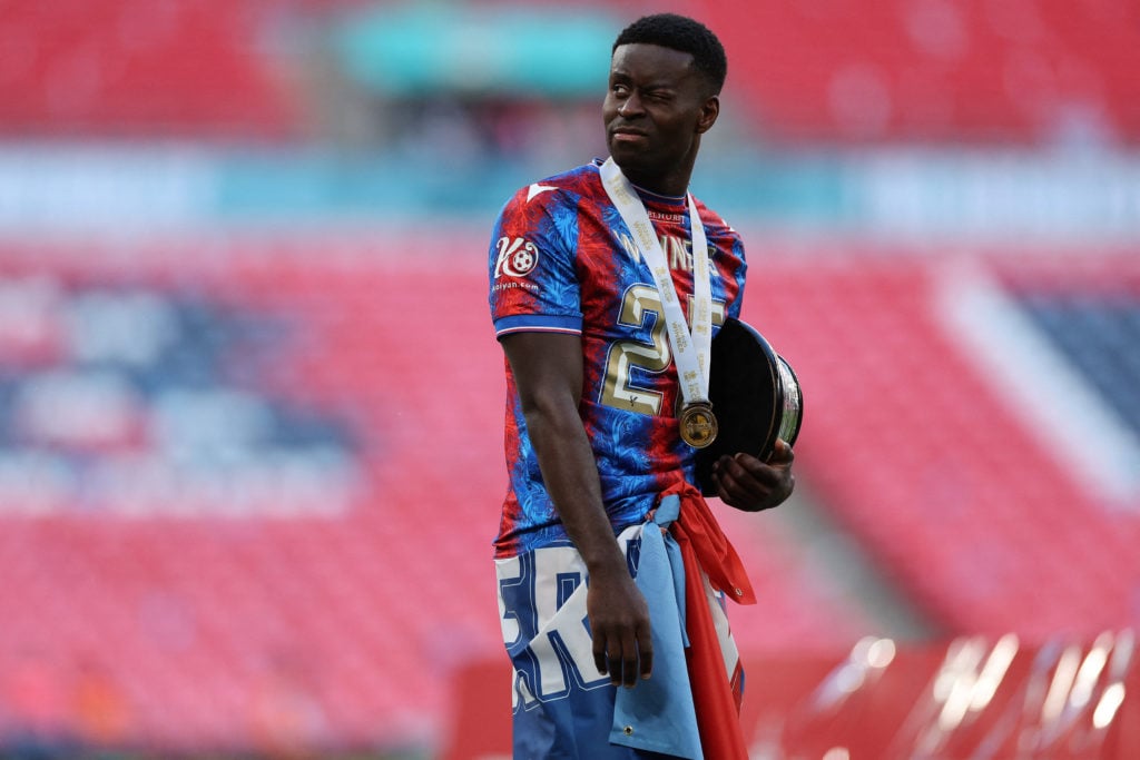 Marc Guehi holding the FA Cup trophy base after Crystal Palace beat Manchester City in the final at Wembley