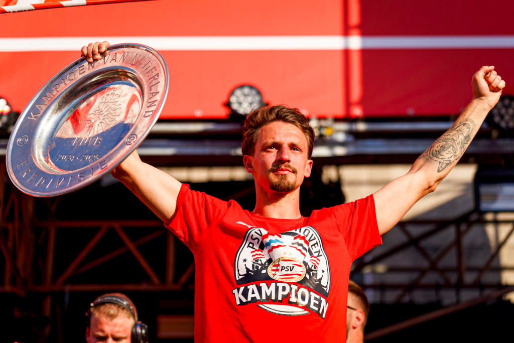 PSV Eindhoven defender Olivier Boscagli holding the Eredivisie title trophy aloft