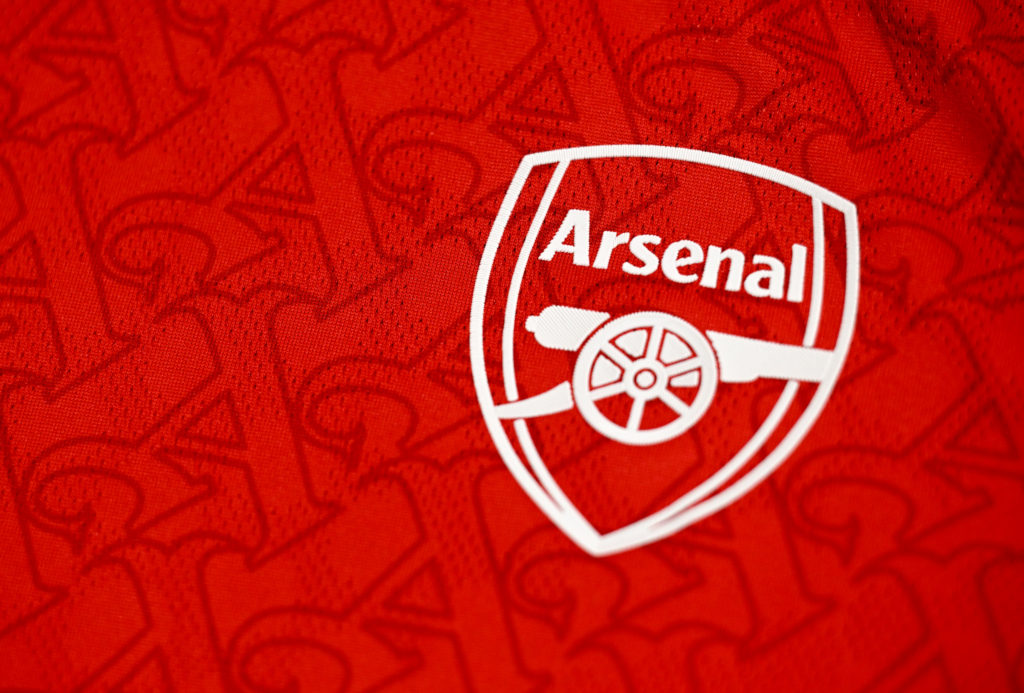 An image of the Arsenal badge on a home shirt hanging in the changing room