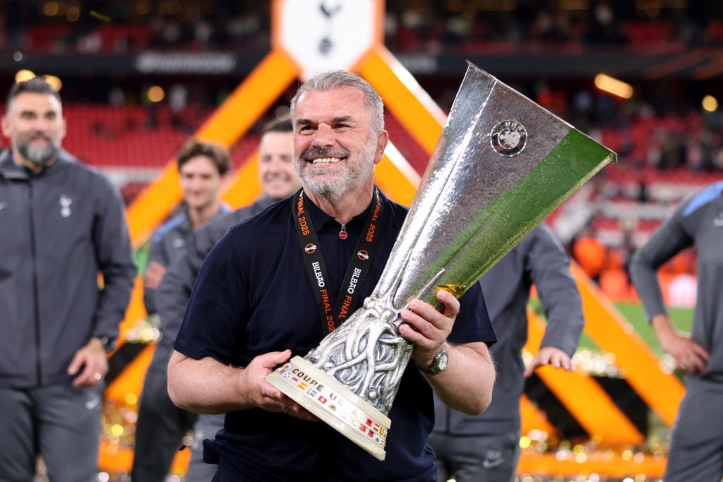 Tottenham manager Ange Postecoglou lifts the Europa League trophy.