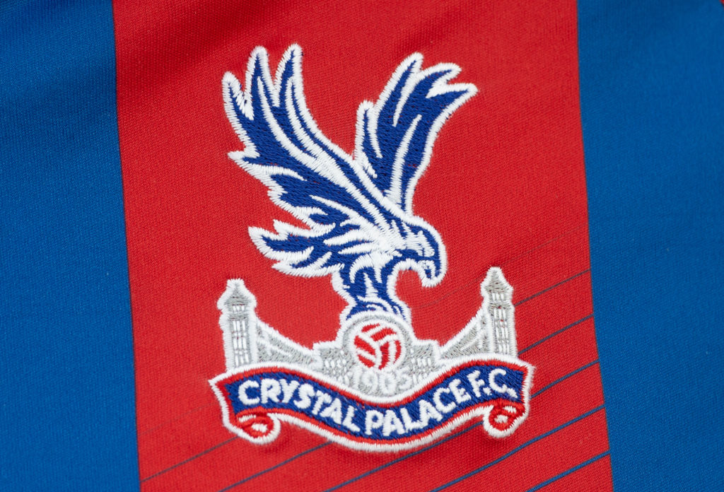 A closeup shot of the Crystal Palace badge on the club's home kit
