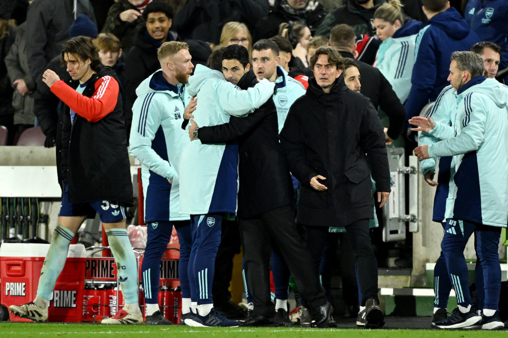 Thomas Frank looks on as Mikel Arteta and Arsenal celebrate.