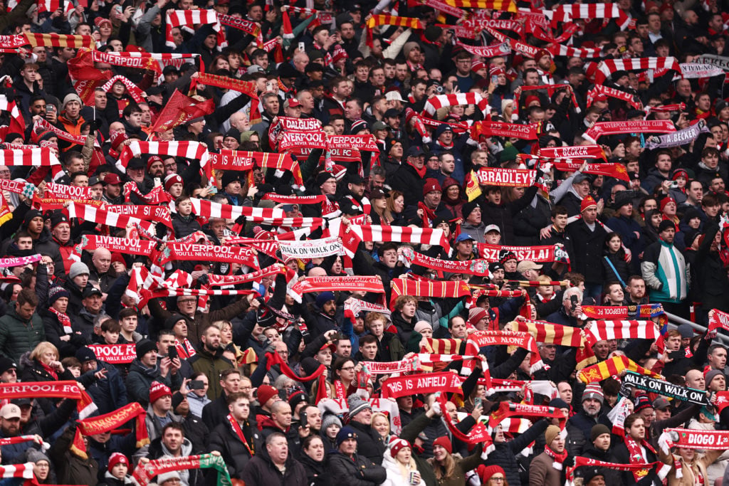 Liverpool fans raise scarves aloft at Anfield