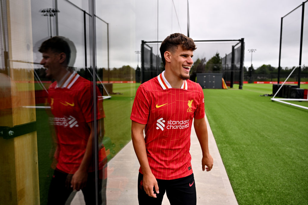 New Liverpool signing Milos Kerkez laughs during his unveiling.