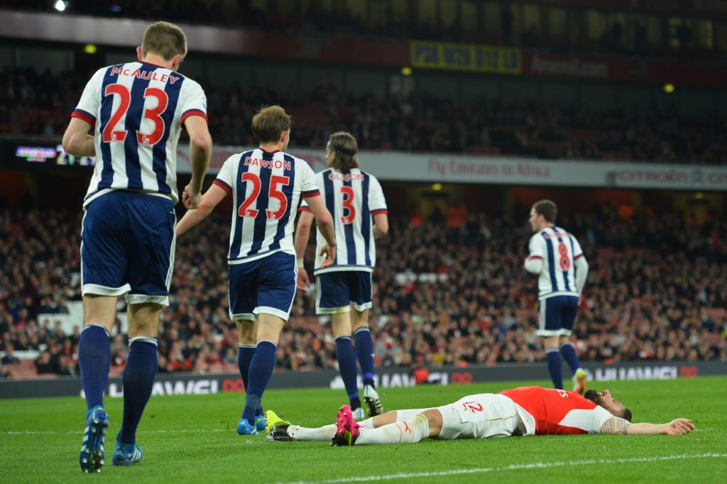 Olivier Giroud lies on the Emirates turf after missing a chance against West Brom during a Premier League match in 2016.