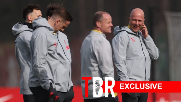 Arne Slot looks on with members of Liverpool's coaching team.