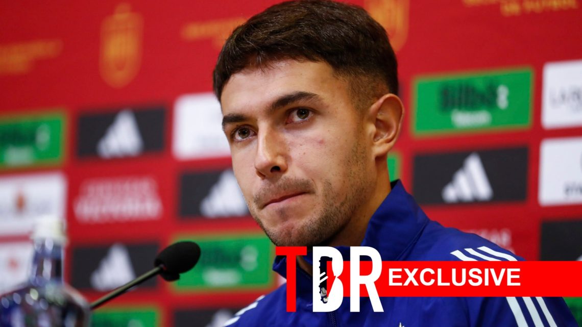 Image of Real Sociedad midfielder Martin Zubimendi during a press conference ahead of a Spain game, overlaid a TBR exclusive banner